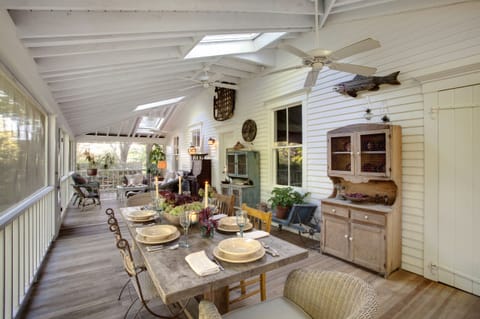 Screen in porch with large seating area and ceiling fans