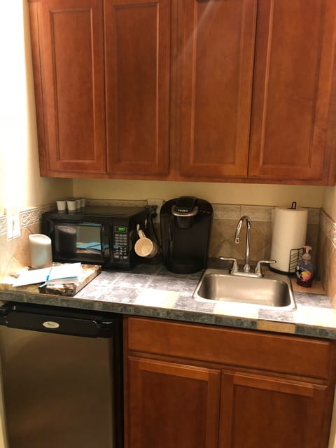 Fridge, microwave, coffee/tea maker, cookware/dishes/utensils