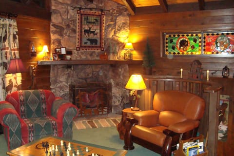 The GREAT ROOM at Rocky Top Lodge with stone wall fireplace. Chess anyone?