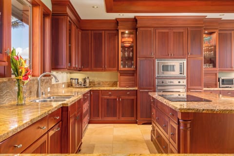 Create island-inspired meals with ease in the gourmet kitchen featuring high-end appliances and elegant finishes.