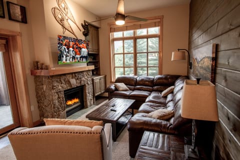 The living area features a fireplace, beautiful leather sectional and 55 inch HD TV