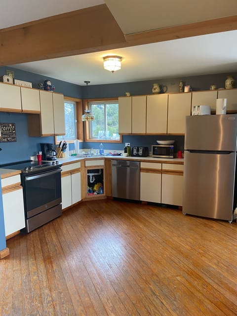 Kitchen with newly installed fridge, oven and dishwasher.