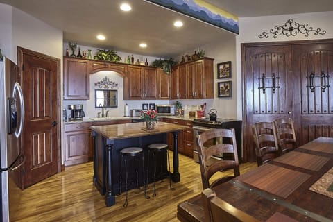 Kitchen with walkin pantry on left and island for food preparation and serving