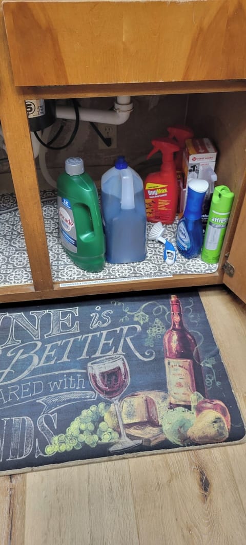 Under kitchen sink with ample supplies.