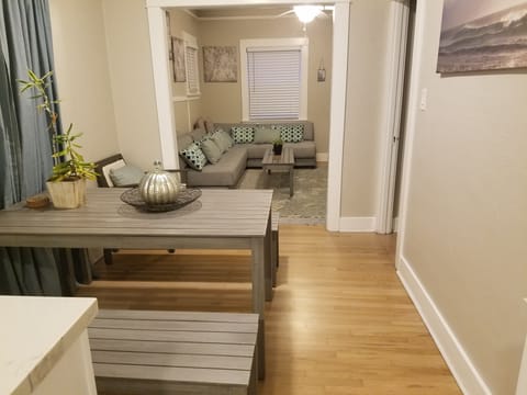 from kitchen through dining room to living room. Main bedroom on right