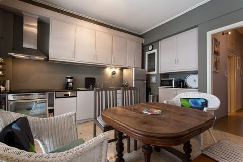 Fully equipped kitchen and dining area with antique table