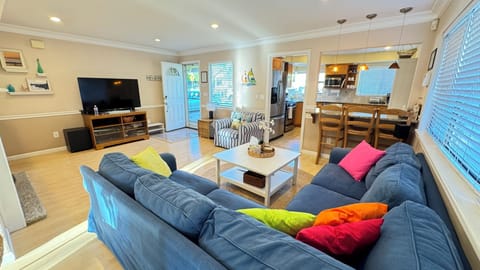 Relax in the bright, colorful living room with large sectional sofa