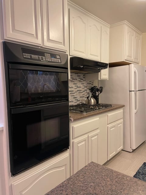 Galley kitchen flows to homes entry and dining table and family room...