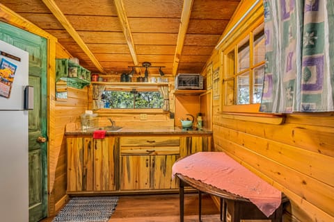 Kitchen fully stocked with cookware, dishes, coffee maker, and more