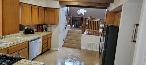Entry into kitchen with 5 steps up into living room area.