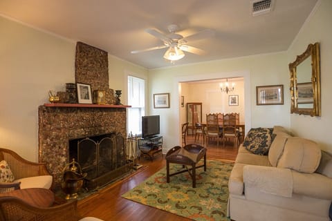 living room with stone stacked fireplace