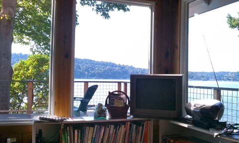 Living room looking out over water. Assorted books, movies and games for guests.