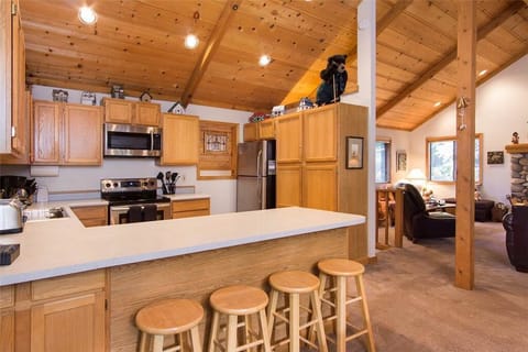 Open-concept kitchen opens to dining room and great room