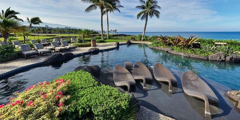 A heated pool, sun loungers