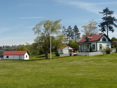 Park grounds, cottage rental on right, History Research Center, and Boat House.