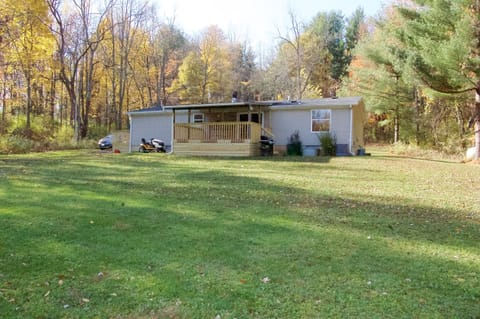 View from back showing covered porch and gas grill.