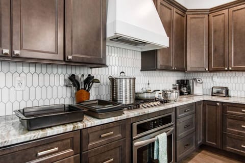 Extensively equipped with various cooking utensils and small appliances, the kitchen is perfect for cooking large meals.