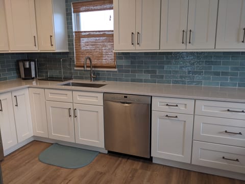 Brand new kitchen with quartz countertops and stainless appliances