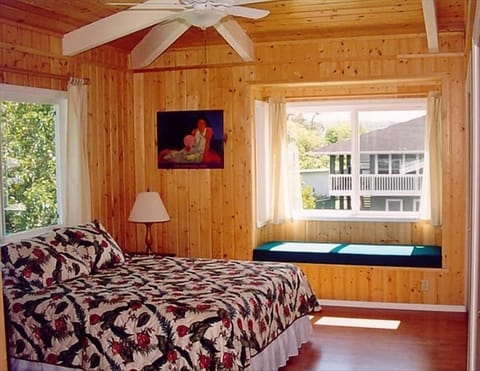 Large bedroom with love seat and ensuite bathroom