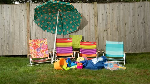 Beach chairs, towels, umbrella, and toys provided