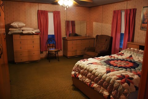 Master BR. Bath is to right. Large closet. Vintage mirrored dressers and bed. 