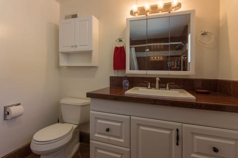 Bathroom with jacuzzi tub, fresh towels, and all the amenities