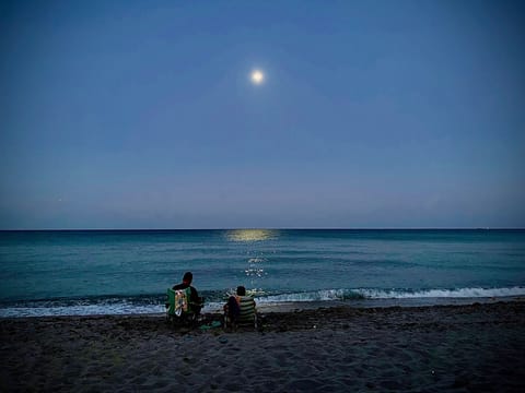 On the beach, sun loungers, beach towels