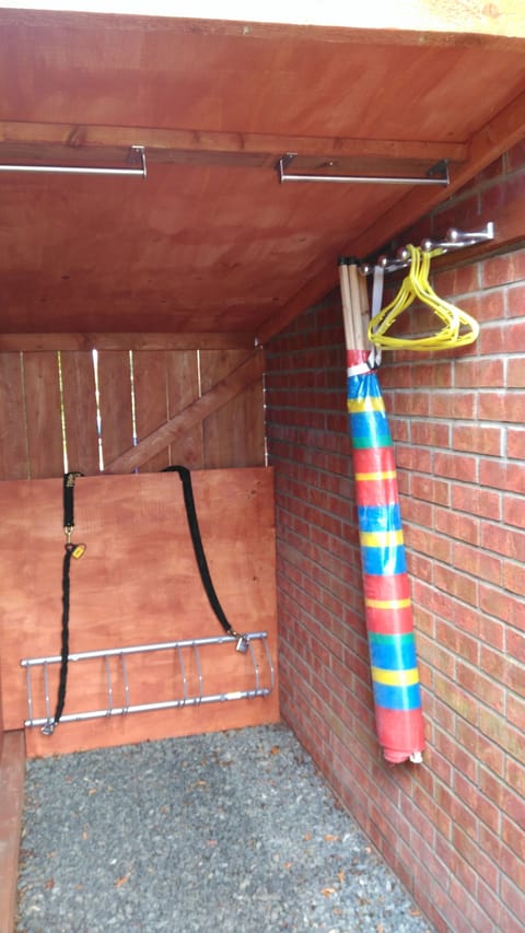 Bike store with hanging space for wetsuits or other wet garments.