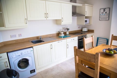 Well equipped kitchen has dishwasher, washing machine, microwave and cooker