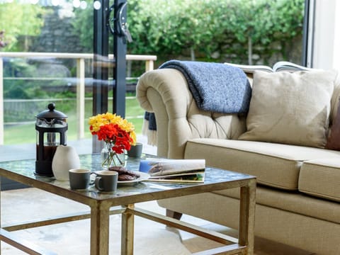 Comfortable sitting room with patio doors leading to garden 