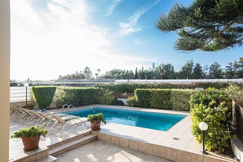 A heated pool, sun loungers