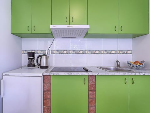 Green, Countertop, Cabinetry, Kitchen, Room, Property, Tile, Furniture, Yellow, Material Property