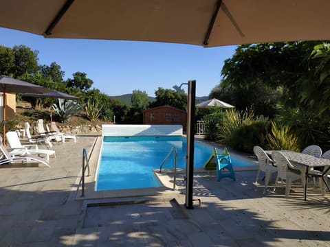 A heated pool, sun loungers