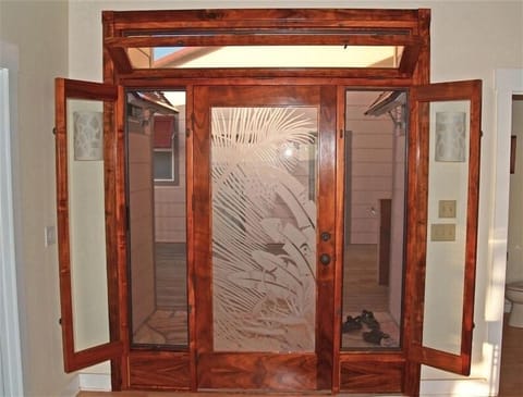The beautiful entrance is made of rare Hawaiian Koa Wood