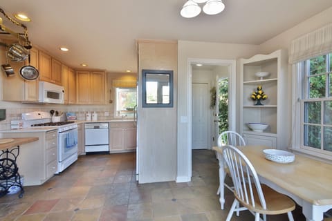 Sunny Kitchen with eating nook and pantry. 

