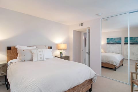 Second bedroom quietly positioned with large mirrored closet