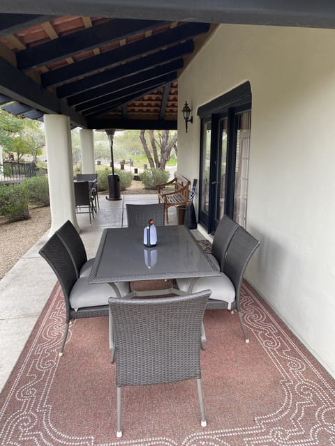 Outdoor dining area with 6-person seating and separate 2-person coffee table
