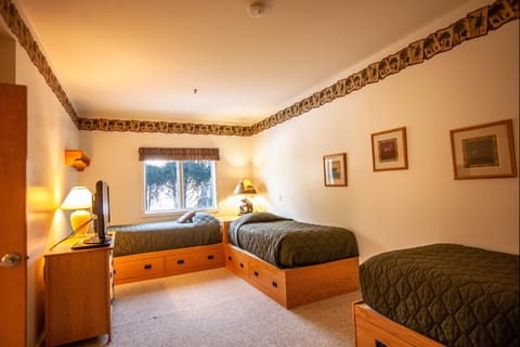 Three twin beds in one of the guest bedrooms
