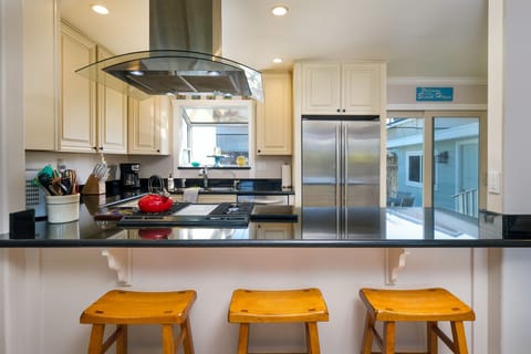Kitchen includes a gas range, high end appliances and a breakfast bar.