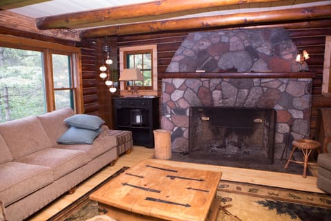 The living room is gorgeous with a fieldstone fireplace and view of the river.
