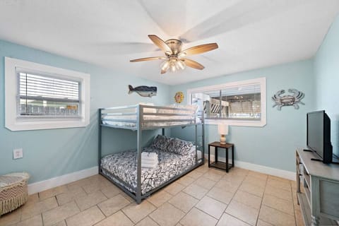 Retreat to this bedroom with a full bunk bed and a smart TV, offering a snug space and modern entertainment for a delightful escape.