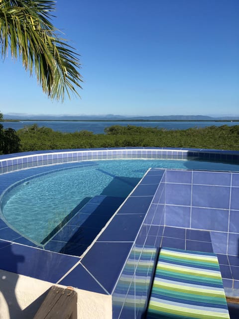 Roof-top pool overlooking Placencia Lagoon and to the Maya Mountains