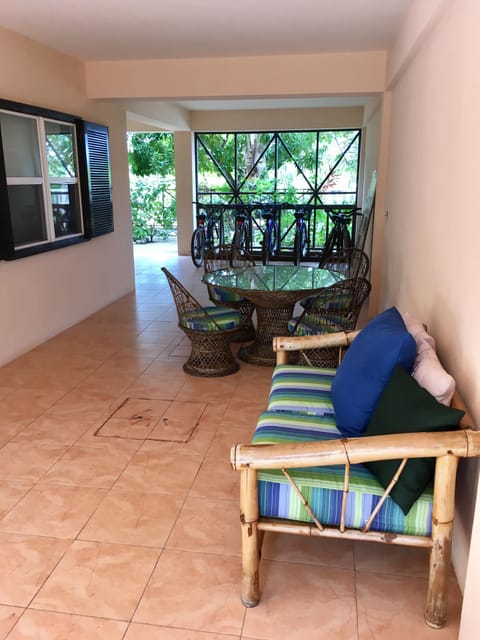 "Breezeway" with dining table and chairs; bicycles in the background