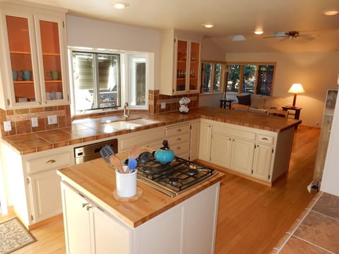 Well-equipped kitchen with modern appliances and bar-stool counter seating for 2