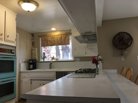 Bright White Kitchen with seating for 12+ separate from Living/Dining Room
