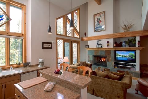 Work area in kitchen has seating, great outdoor and indoor views