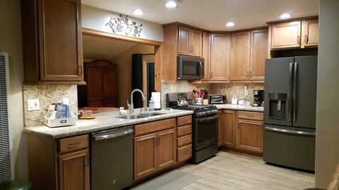 Newer kitchen and appliances. Gas oven/range with center griddle.