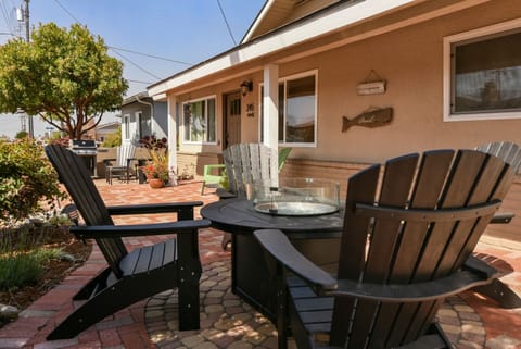 Enjoy the patio area with comfortable seating and a fire pit