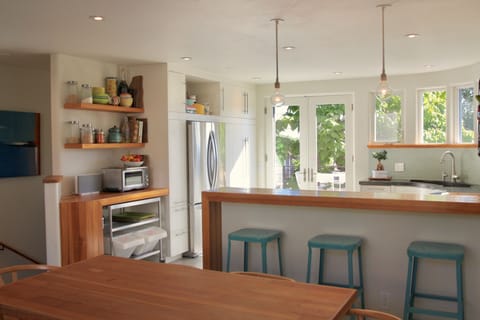Cheerful kitchen with eclectic pottery and pops of color