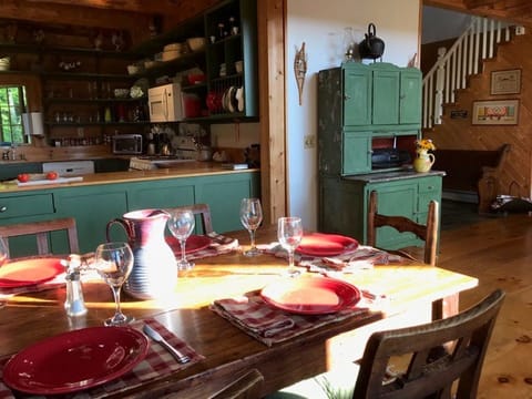 The antique dining table can seat up to eight hungry visitors.